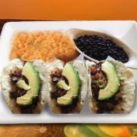 Tacos Los Tres · Two flour tortilla tacos filled with steak with melted Chihuahua cheese, sliced avocados, an...