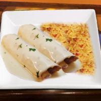 Burritos Mexicanos · Two beef tip burritos topped with our delicious melted cheese sauce.