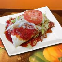 Burritos Deluxe · Two burritos- one chicken and re-fried beans and one beef and refried beans. Topped with let...