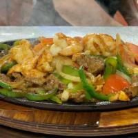 Half Fajitas Texanas · Mixed beef, chicken and shrimp cooked with bell peppers and onions, served with salad, homem...