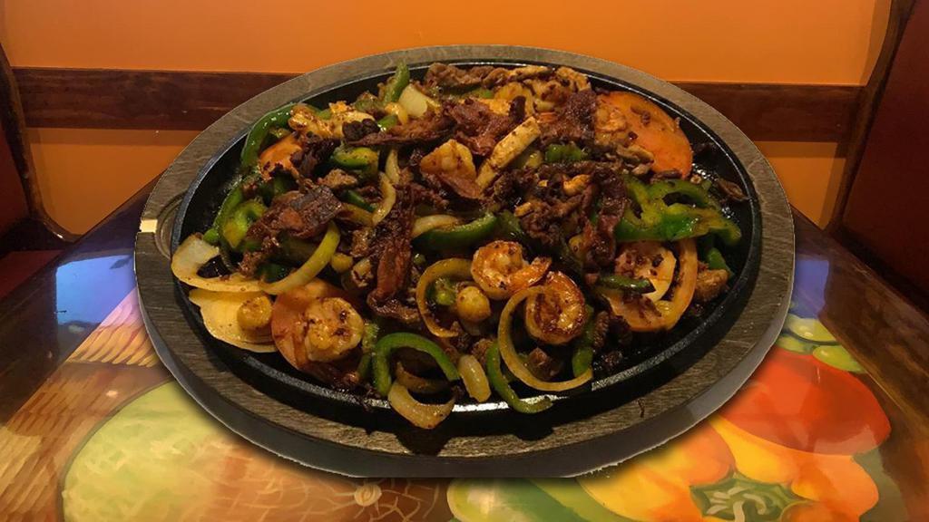 Parrillada Mexicana For 2 · Scallops, shrimp, chicken, beef, pork, bacon and chorizo cooked with bell peppers, onions, and tomatoes. Served with rice and beans.