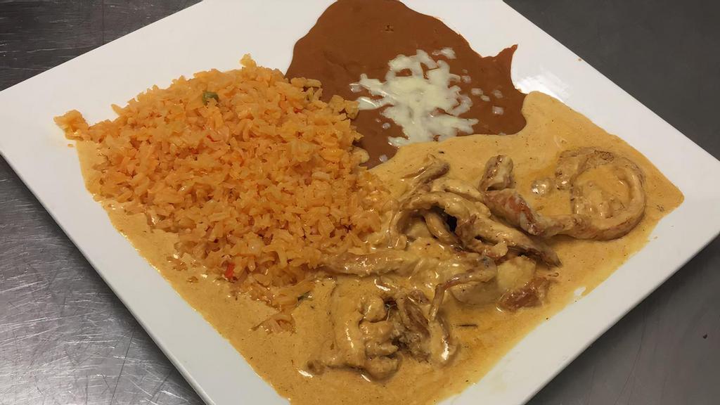 Pollo A La Crema · Strips of grilled chicken prepared with our sour cream chipotle sauce. Served with Spanish rice, refried beans, and flour tortillas.