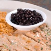 Tiras De Pollo · Strips of chicken with chipotle cream. Served with rice and black beans.