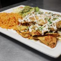 Chilaquiles Mexicanos · Tortilla chips covered with special sauce, chicken, and cheese. Served with Spanish rice, le...