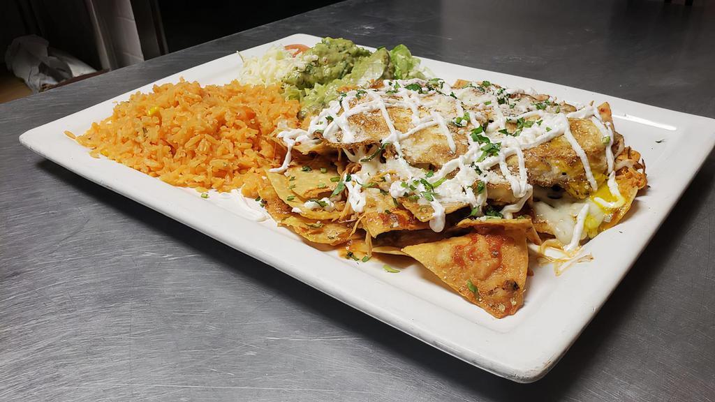 Chilaquiles Mexicanos · Tortilla chips covered with special sauce, chicken, and cheese. Served with Spanish rice, lettuce, guacamole. Sour cream, and tomatoes.