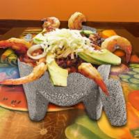 Piedra Y Mar · Grilled shrimp, octopus, scallops and tilapia served in a molcajete with rice and tortillas.