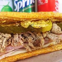 The Cuban Jibarito · Cuban pulled pork, ham, Swiss, mustard, pickles, with our signature Mojo sauce on two fried ...