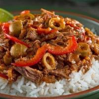 Ropa Vieja · National Dish of Cuba. Shredded flank steak cooked in a red sauce with onions, red bell pepp...