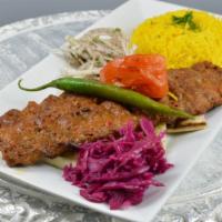 Adana Kabob · Two skewers of chargrilled ground lamb and beef mixed with herbs and Turkish spices.