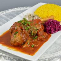 Lamb Shank · Braised lamb shank, served with homemade special lamb sauce. Served with rice and salad.
