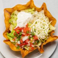 Taco Salad · Large crispy flour tortilla topped with beans seasoned chicken, lettuce, tomatoes, sour crea...