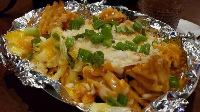 Boot Cheese Fries · Blend of mozzarella and cheddar cheese melted over a large portion of seasoned waffle fries. Garnished with grated parmesan and green onion.