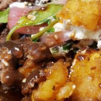 French Tots · Ground beef, rosemary demi glace, white truffle vinaigrette arugula, goat cheese crumble and...