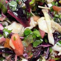 Cabbage Salad · Vegetarian. Finely sliced cabbage, tomatoes, parsley, scallions, mint, olive oil, vinegar, a...