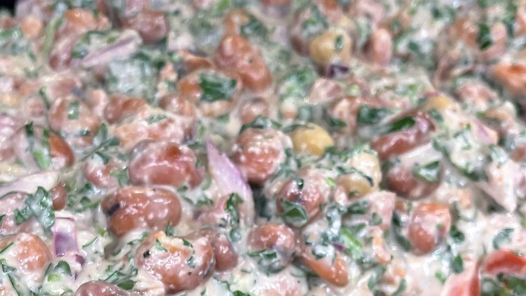 Fava Bean Salad · Fava Beans, tomato, yellow onion, olive oil, lemon juice, parsley, mint, garlic & paprika.