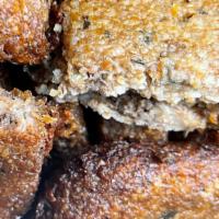 Kibbeh · Lean ground beef, cracked wheat, onions, spices, and pinenuts; layered and baked. Served hot...