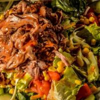 Bbq Salad · Hickory pulled pork, tomatoes, cheddar cheese, cucumbers, corn, and bacon on a bed of mixed ...