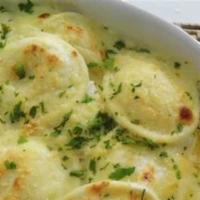 Ravioli Alfredo · Served in a special blend of white cream sauce. Served with garlic or plain knots.