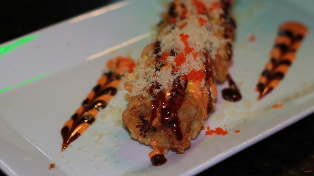 Dynamite Roll · Hot and spicy. Chopped three kind of fish deep fried with spicy mayo, eel sauce masago and crunch on top.