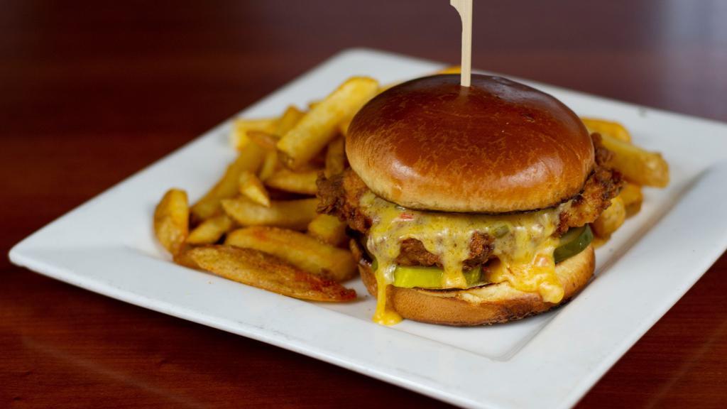 Sweet + Cheesy Fried Chicken Sandwich · Boneless chicken breast hand breaded and golden fried, topped with ooey gooey southern pimento cheese with just a hint of jalapeño, honey, pickles, all on a fresh brioche bun.   Served with thick cut fries.