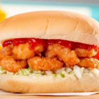 Shrimp Burger · A North Carolina coastal classic. Golden hand-breaded shrimp on a bed of slaw, topped with k...