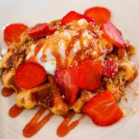 Strawberry Cheesecake · Toasted Belgian waffle with cream cheese icing, fresh strawberries, strawberry jam, graham c...