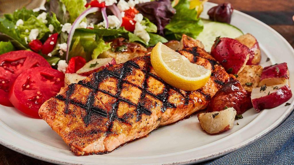 Grilled Salmon Family Feast For 4 · Seasoned chargrilled blackened salmon that includes a choice of salad with dressing, choice of side, and choice of baked pita chips or soft pita