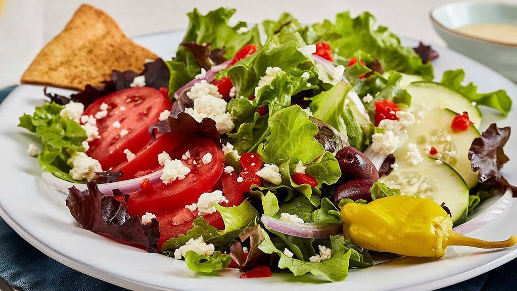 Greek Salad · Fresh mixed lettuces, tomatoes, cucumbers, roasted red peppers, red onions, feta, pepperoncini, kalamata olives and Greek dressing. (410 cal)