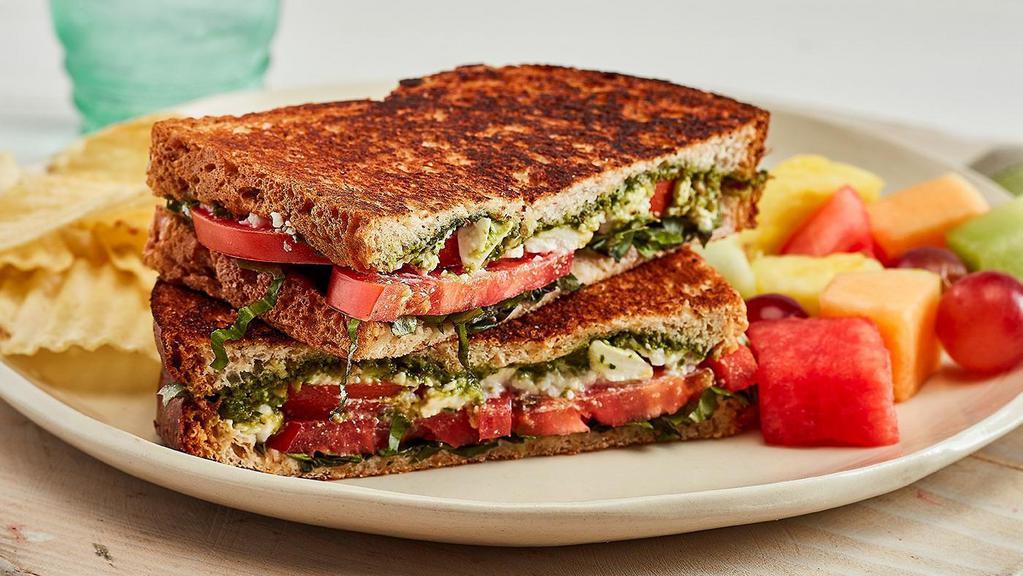 Tomato Basil Sandwich · Feta, tomatoes, fresh basil, and basil-pesto sauce, on toasted wheat bread, served with chips and your choice of a homemade side **CONTAINS NUTS**