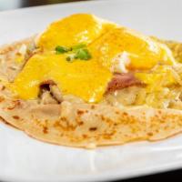 Eggs Benedict Crepe · A Crepe topped with White Sharp Cheddar, Ham,  2 Poached Eggs*, Green Onions and Paprika. Se...