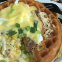 Eggs Benedict Waffle · A rich Belgium waffle topped with White Sharp Cheddar, Ham, 2 Poached Eggs*,  Green Onions a...