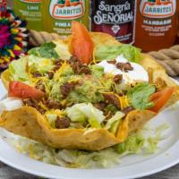 Taco Salad · Taco salad is served on a crispy flour tortilla shell with choice of chicken or beet; lettuc...