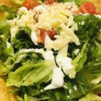 Taco Salad · Crispy flour tortilla shell filled with ground beef or chicken tinga, beans, lettuce, tomato...