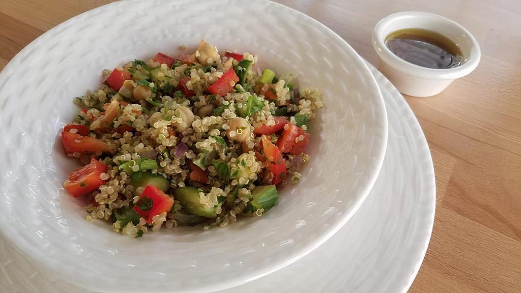 Quinoa Salad · Our amazing middle eastern Quinoa Salad made with quinoa, chickpeas, cucumber, bell pepper, red onion, parsley, and a little garlic.