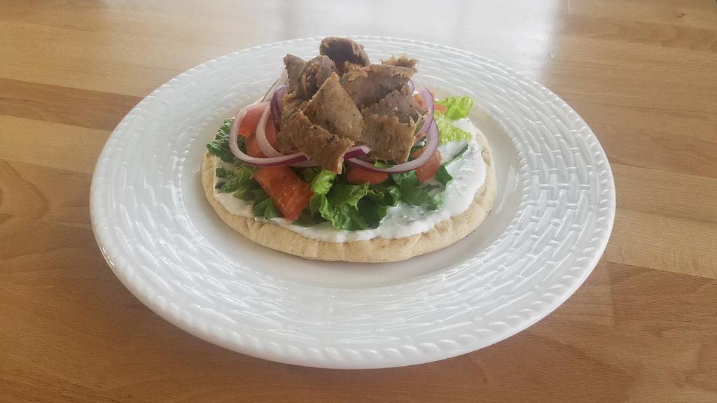 Gyro Sandwich · Our famous thinly sliced gyro topped with tzatziki, lettuce, tomato, and onion! Wrapped in warm fresh pita bread!