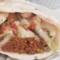 Falafel Wrap · Vegetarian. Vegan. Our famous Falafel Wrap topped with hummus, cucumber, tomatoes, tahini, a...