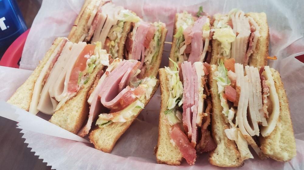 The Arbor Club · Triple decker sandwich on white texas toast with turkey, ham, bacon, Swiss cheese, Provolone cheese, lettuce, tomato, and mayo.