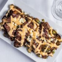 Brussels And Bites · Fried Brussels sprouts, seared beef tips, feta cheese and white BBQ sauce.