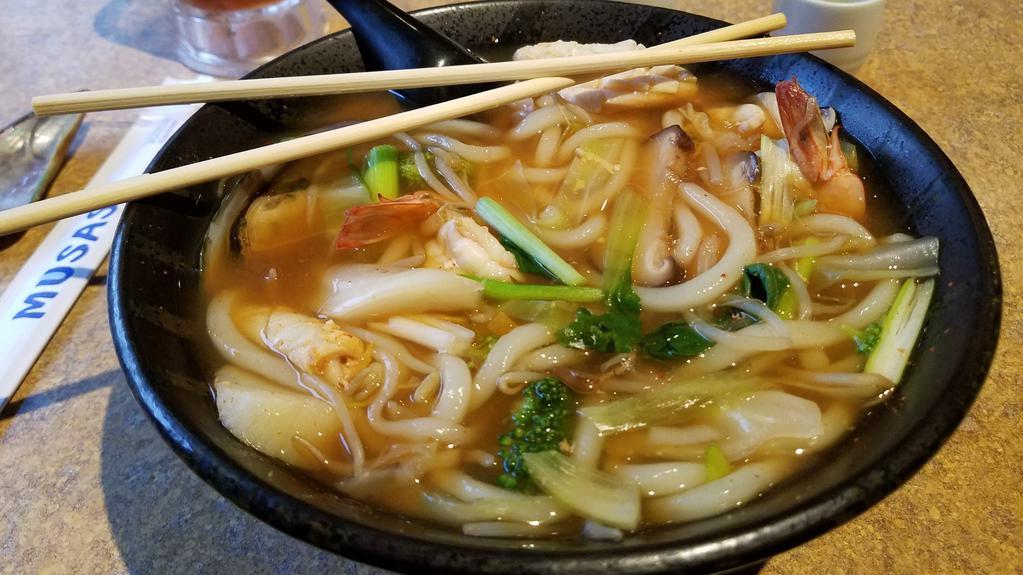 Spicy Seafood Udon · Seafood Stew served with Thick Japanese Noodles.