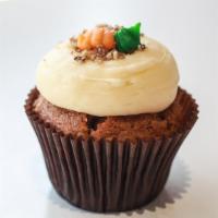 Carrot Cupcake · Carrot cake with cream cheese icing, topped with pecan crumbles, and a buttercream carrot.