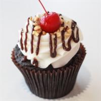 Hot Fudge Sundae Cupcake · Chocolate cake with a fudge filling, buttercream icing, drizzled with fudge, topped with sun...
