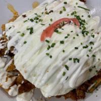 Chilaquiles · Crispy corn tortilla chips toasted with green tomatillo salsa. topped with crema queso fresc...
