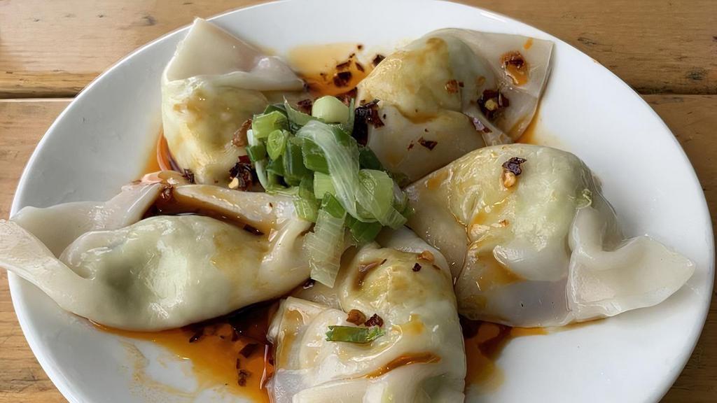 Steamed Dumplings · Five handmade edamame dumplings with soy sauce, house chili, and scallion oils.