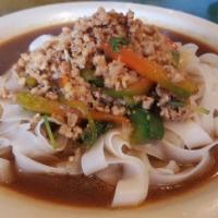 Thai Drunken Noodle · Spicy. Wide rice noodles, your choice of protein, onion, carrot, red pepper, and Thai basil ...