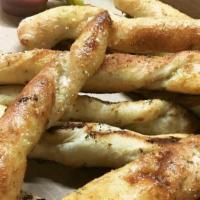 Garlic Breadsticks · Our dough rolled in butter, Parmesan/Romano cheese, garlic, and baked to perfection. Served ...