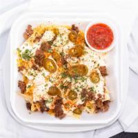 Fh Jerk Beef Nachos · White queso, Cheddar, and jalapeños.