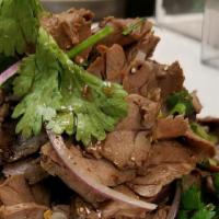 Goi  · Sliced grilled beef with onion and cilantro tossed in lemon dressing. Served with a wedge of...