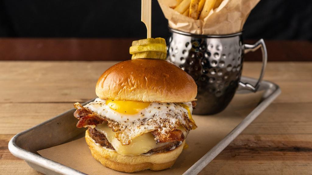 All Nighter · USDA Choice beef cooked medium-well, sunny egg, house-made spicy candied bacon, white cheddar, garlic aioli, pickle chips