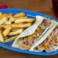 Pulled Pork Tacos · Two soft flour tortillas filled with tender pulled pork and Carolina Gold BBQ sauce, green c...