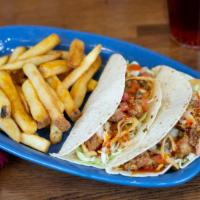 Chicken Tacos · Diced chicken tenders, mango habanero sauce, green cabbage, housemade Pico, and crispy onion...